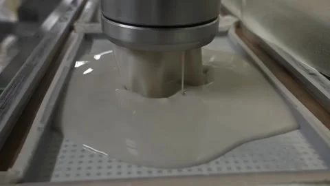 Machine Dispensing Starch Batter Into Molds on a Line Stock Footage 340009482