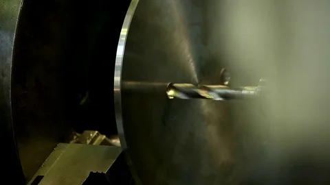 Machine drill makes a hole in a steel circle closeup Stock Footage 76856893