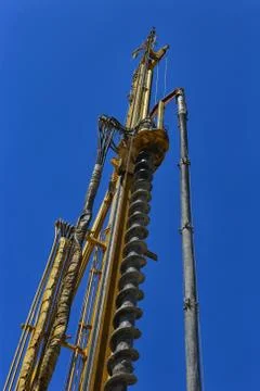 The machine for drilling under piles, against the background of a clear blue  Stock Photos