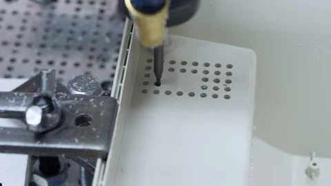 The machine drills holes in a plastic part. Stock Footage 130066272