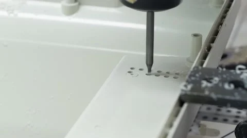 The machine drills holes in a plastic part. Stock Footage 130241505