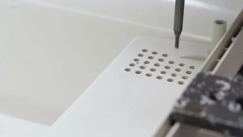 The machine drills holes in a plastic part. Stock Footage 130650259