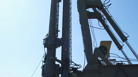 The machine drives a pile wooden structure into the ground. Construction of the  Stock Footage 123871669