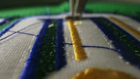 Machine embroiders decorative elements of hockey club logo Stock Footage 143525804