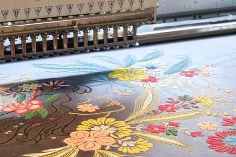 Machine embroidery close-up. Floral pattern as industrial concept Foto stock