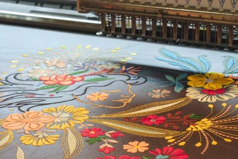 Machine embroidery close-up. Floral pattern as industrial concept Stock Photos