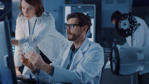 Machine Engine Development Engineer Working on Computer at His Desk, Talks Stock Footage 104854658