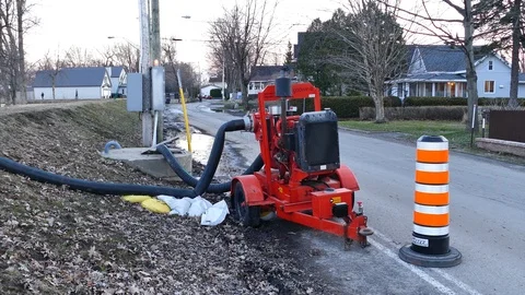 Machine extracting water during flooding season Stock Footage 114690573