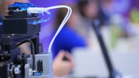 Machine extrudes plastic while people work nearby Stock Footage 345024973