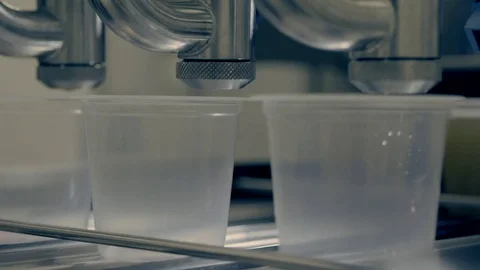 Machine filling cans with liquid Stock Footage 78032826
