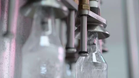 Machine filling transparent bottles Stock Footage 245800033