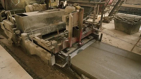 Machine forming concrete and making smooth edge. The concrete solution is poured Stock Footage 129633284