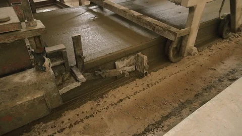 Machine forming concrete and making smooth side of plate. The concrete solution Stock Footage 129633370
