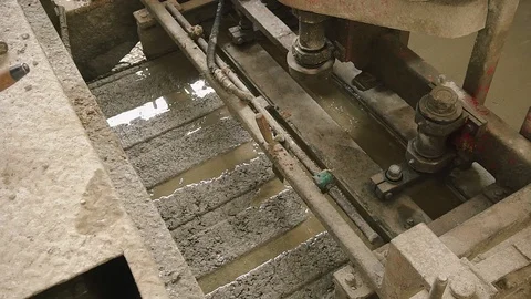 Machine forming concrete and making smooth top. The concrete solution is poured Stock Footage 129633403