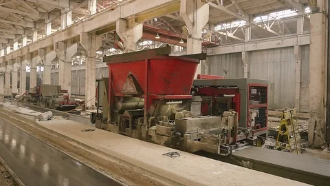 Machine forming concrete.The concrete solution is poured into the formwork Stock Footage 129633437