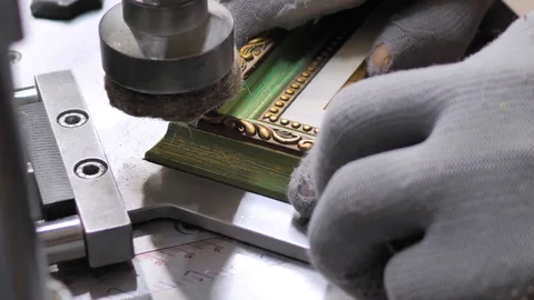 Machine in the framing Workshop. man makes a frame for a picture made of beads Stock Footage 128737882
