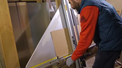 Machine in the framing Workshop. man makes a frame for a picture made of beads Stock Footage 130801306