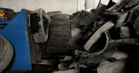 Machine getting metal wires from inside of old rubber tire on processing plant. Stock Footage 129903260