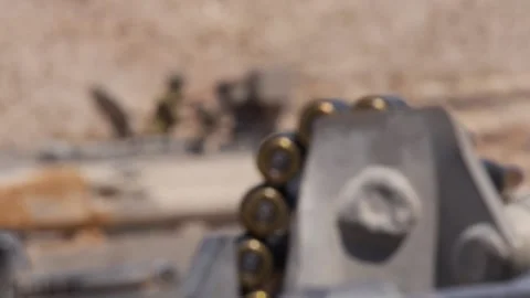 Machine gun bullet chain moves in slow motion Stock Footage 168537001