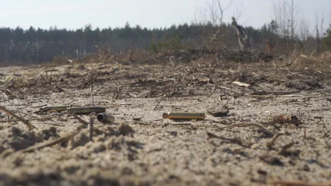 Machine gun casings fall to the ground Stock Footage 266781566