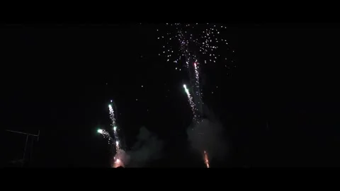 Machine gun fire works shooting at night sky, close up for one minute Stock Footage 294010313