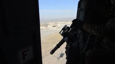 Machine gunner during a tactical flight over the mountains of Afghanistan 스톡 동영상 44654945