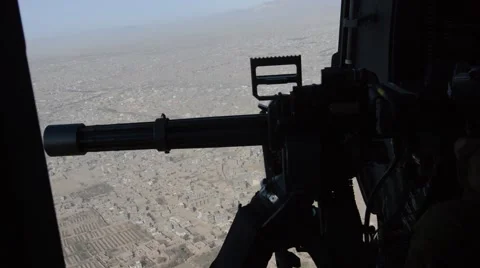 Machine gunner during a tactical flight over the mountains of Afghanistan Stock Footage 44656019