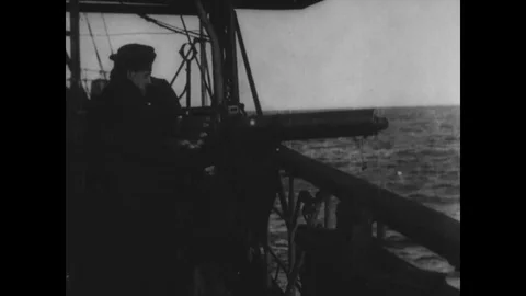 Machine gunner fires and rowboat goes alongside of hallbjork ship - 1918 Stock Footage 86485177