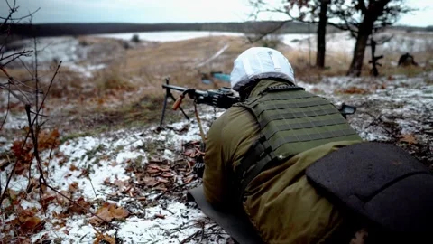A machine gunner fires a machine gun on a military field Stock Footage 288826286