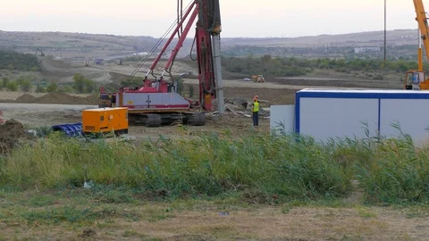 Machine installation of piles into the ground Stock Footage 123586631