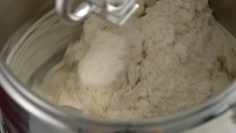 Machine knead bread dough. Raw dough in a industrial bakery dough mixer, food Stock Footage 141365608