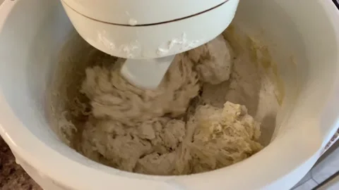 Machine knead bread dough. Raw dough in a industrial bakery dough mixer, food co Stock Footage 203947788