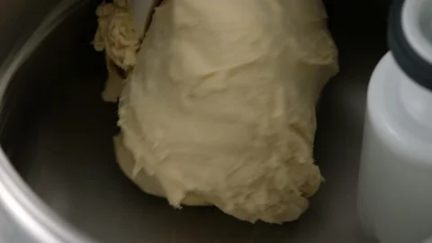 Machine kneading bread and rolls dough. Raw dough made from butter, flour, sugar Stock Footage 145542958