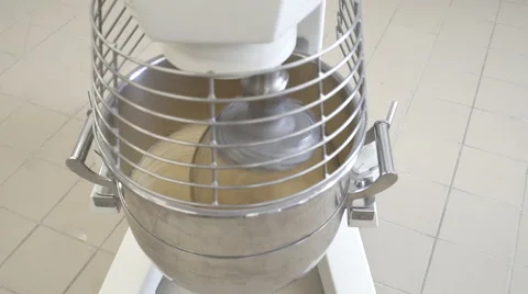 A machine kneading dough, at a bakery. Video stock 68490878