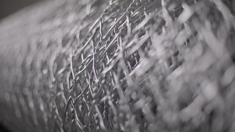 Machine knitting and rolling wire mesh fence, macro shot, close up, rack focus. Stock Footage 84121866