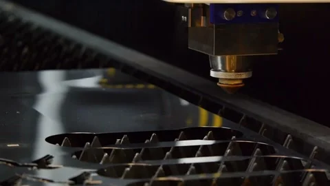 The machine laser cuts out a piece of iron. Sparks fly in all directions. Stock Footage 101549519