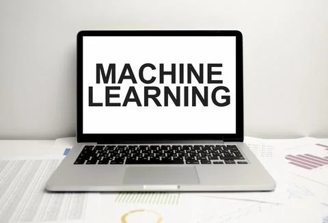 Machine learning words on laptop display and charts Stock Photos