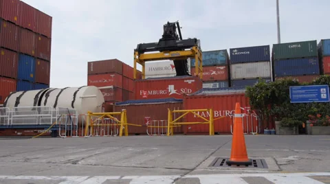Machine lifting a container in the port of Cartagena, Colombia Stock Footage 32148346