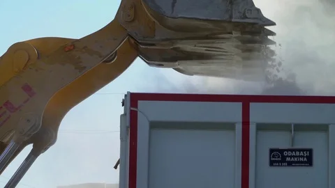 Machine loads trucks with rubble to clear streets of Raqqah, Syria Stock Footage 94565363