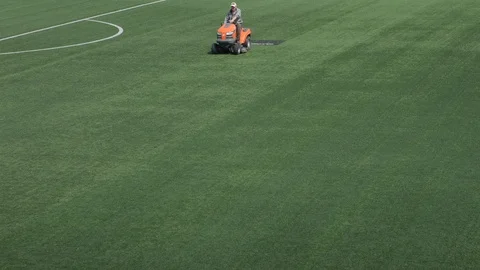 Machine for maintenance of artificial turf. lawn rides on a football field. Stock Footage 108628926