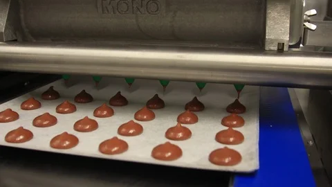 Machine making milk chocolate candy buttons dessert treat automated Stock Footage 118574195