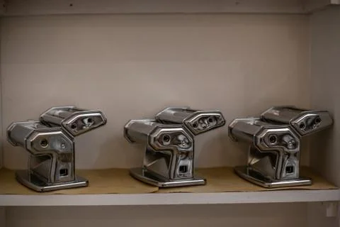 Machine for making pasta by hand on display in a kitchen in Italy - 2 Stock Photos