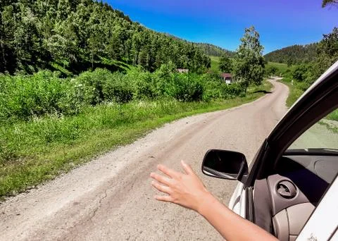 Machine with a man on a road in the mountains Stock Photos