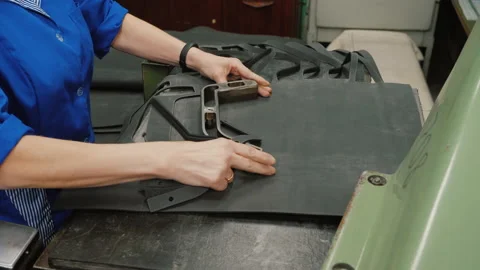 Machine manufacture rubber gasket using template, worker makes rubber parts Stock Footage 135993310