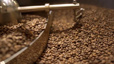 Machine mixes freshly roasted coffee beans in a roaster, close up Stock Footage 170696897