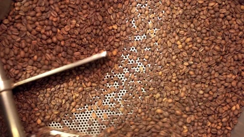 Machine mixes freshly roasted coffee beans in a roaster, close up Stock Footage 170697383