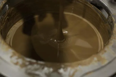 Machine for mixing chocolate. Close up Stock Photos