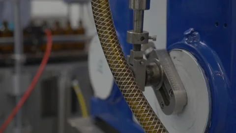 Machine moving in factory with bottles in the background Stock Footage 137282259