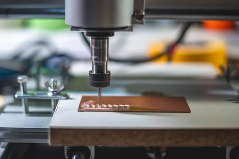 Machine with numerical control CNC carries out milling of printed circuit b.. Stock Photos