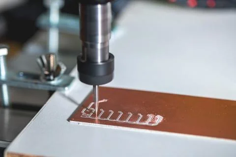 Machine with numerical control CNC carries out milling of printed circuit b.. Stock Photos